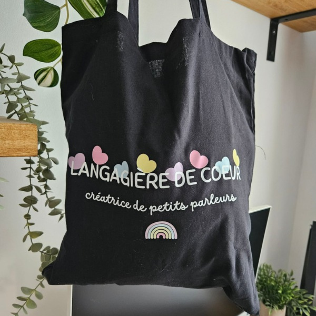 Tote bag noir Langagière de cœur avec cœurs colorés et inscription créatrice de petits parleurs